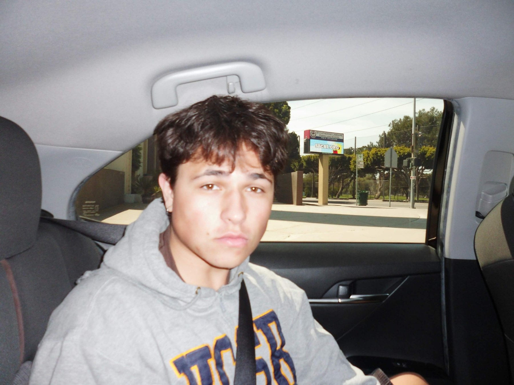 Portrait of Nicholas seated inside a car
