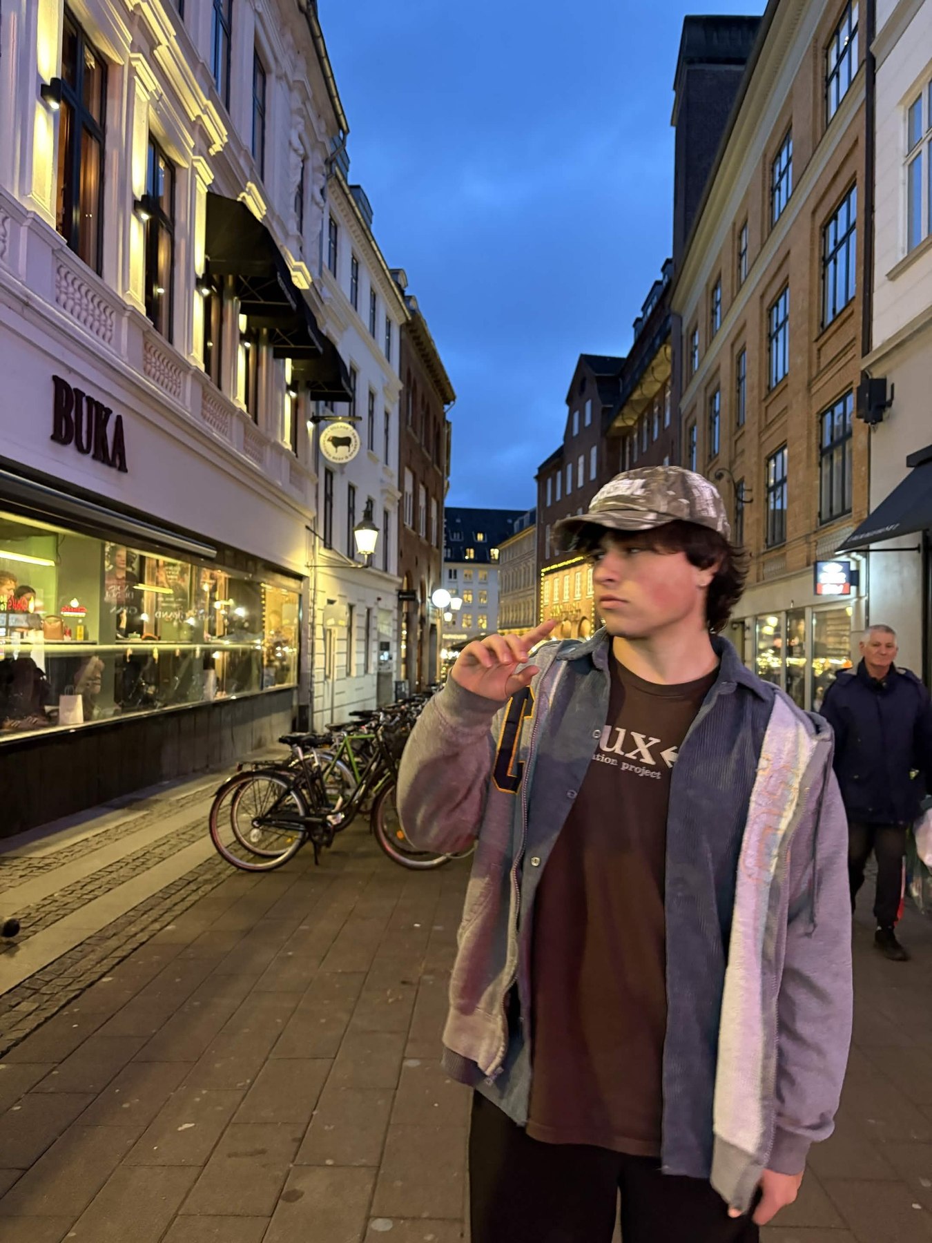 Portrait of Nicholas standing on a city street
